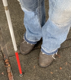 a photo of a young child's shoes and cane a photo of a young child's shoes and cane